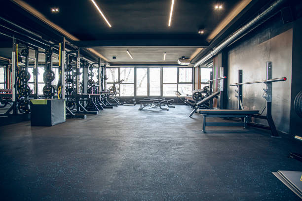 Excercise equipment in a modern gym, benches and weights. No people